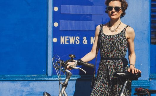 Woman on a bike next to the word 'news'