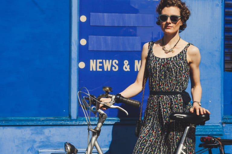 Woman on a bike next to the word 'news' Sustainable Fashion links