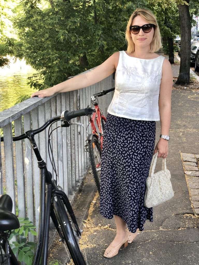 Laura wearing a secondhand linen top and blue skirt during a week of outfits in July.