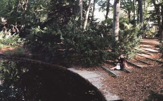 Woman in the woods wearing secondhand skirt and blazer