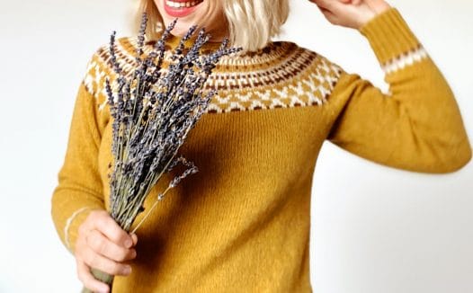 Woman wearing wool jumper and holding dried lavender