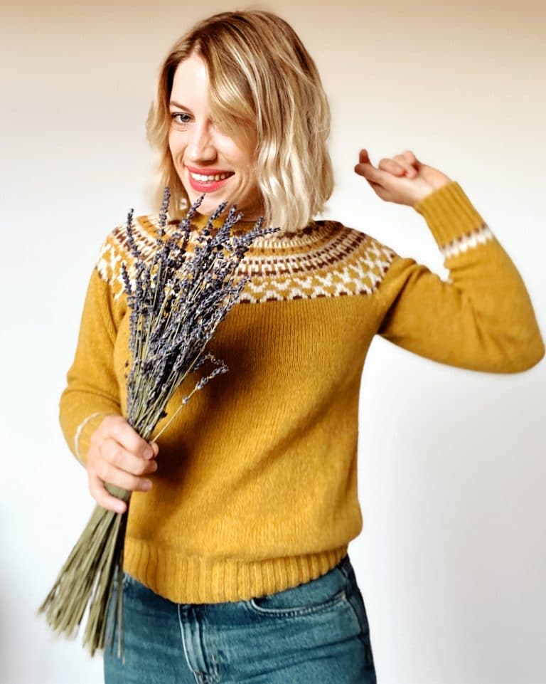 Woman wearing wool jumper and holding dried lavender