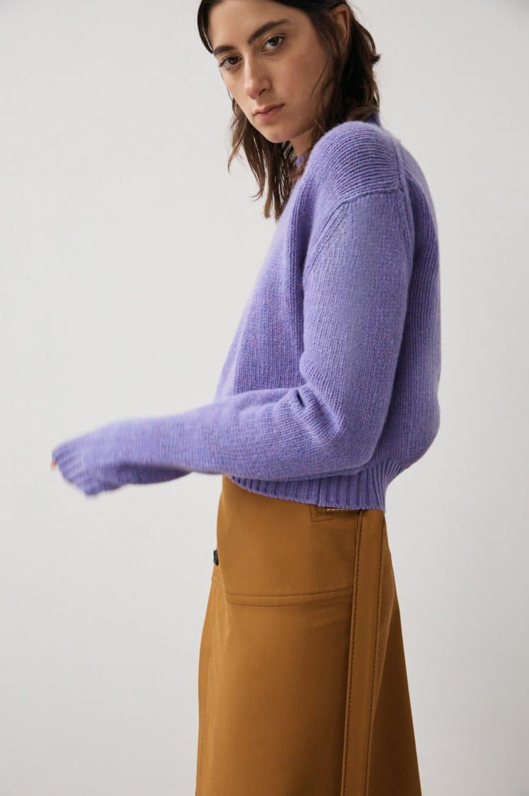 Lilac wool sweater worn with skirt.
